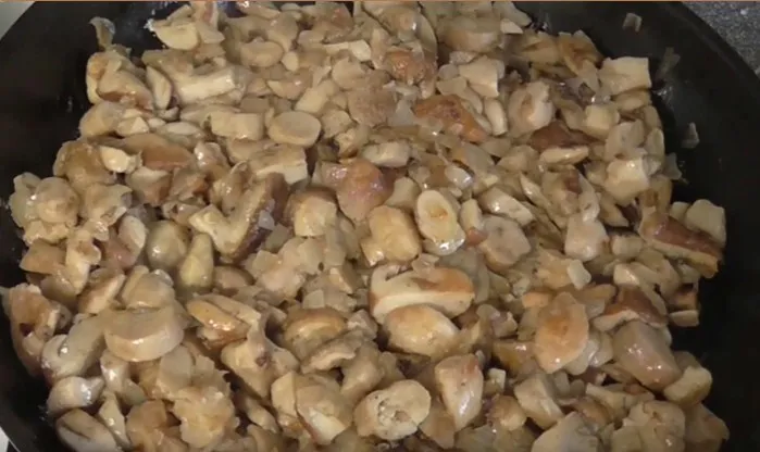 Обжарьте грибы на гриле с чесноком и луком.