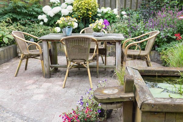 wooden-table-and-chairs-in-a-ornamental-garden